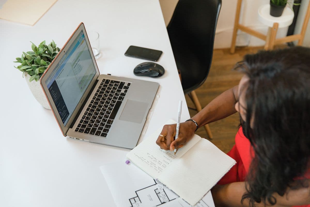 Sketching out a store layout next to a laptop: build pages that answer buyer questions